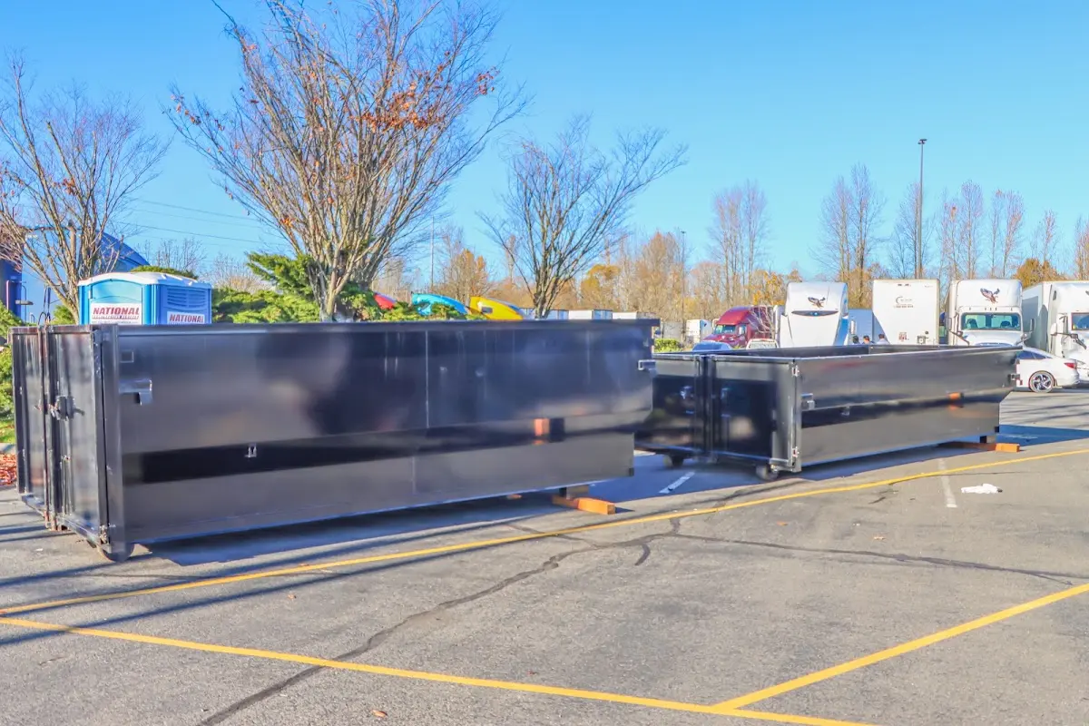 Professional dumpster rental service with roll-off container on residential driveway in Brook Park